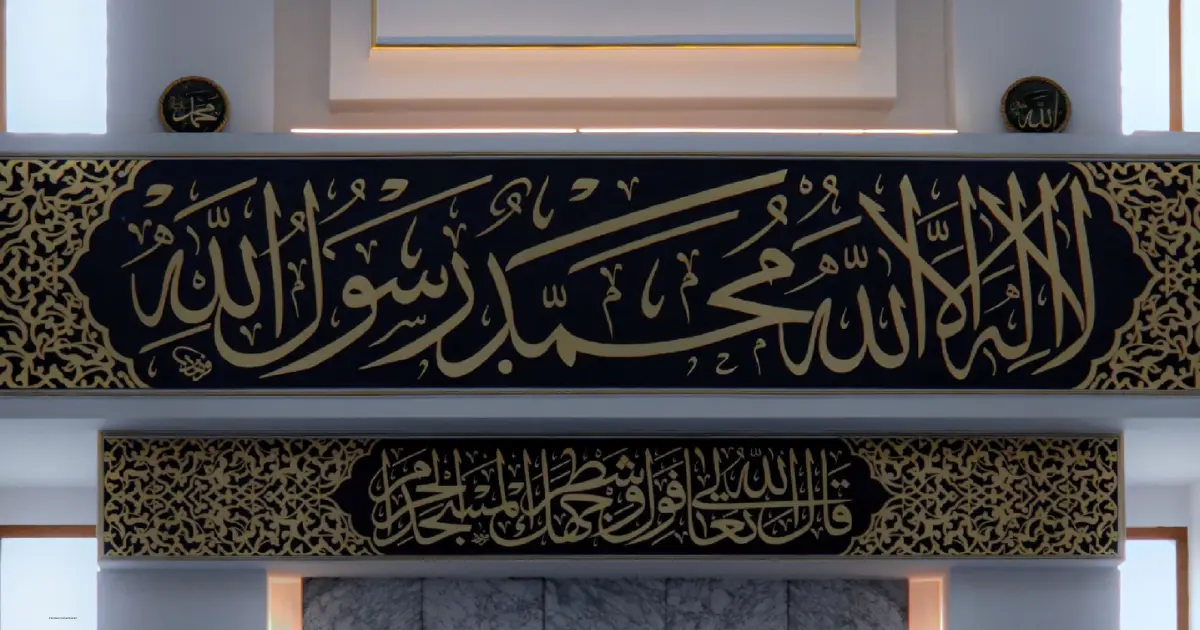 Learn Kalma online – Arabic calligraphy of Kalma Shahada "La ilaha illallah Muhammad Rasulullah" displayed in gold Thuluth script on black background.